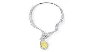 A diamond necklace that features a 100.02 Fancy Intense yellow diamond. The pendant is done in the shape of a musical instrument. A diamond necklace that features a 100.02 Fancy Intense yellow diamond. The pendant is done in the shape of a musical instrument.