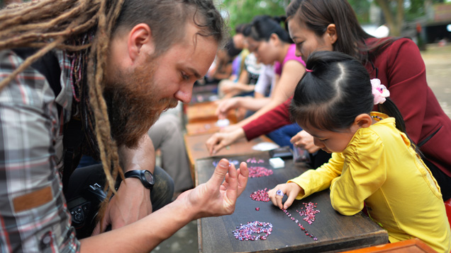 Field gemologist checks spinel at Vietnamese market Field gemologist checks spinel at Vietnamese market