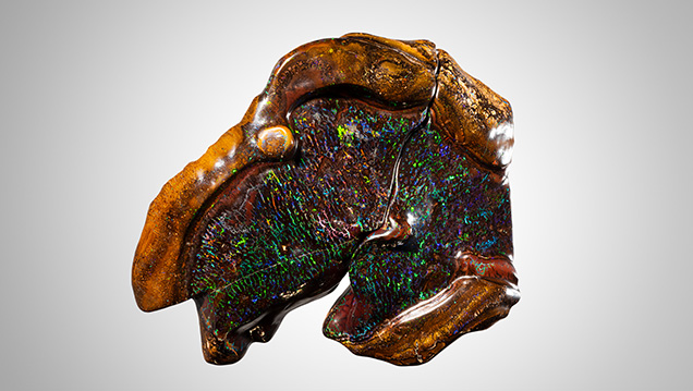 Broken boulder opal with light pattern of color. Broken boulder opal with light pattern of color.
