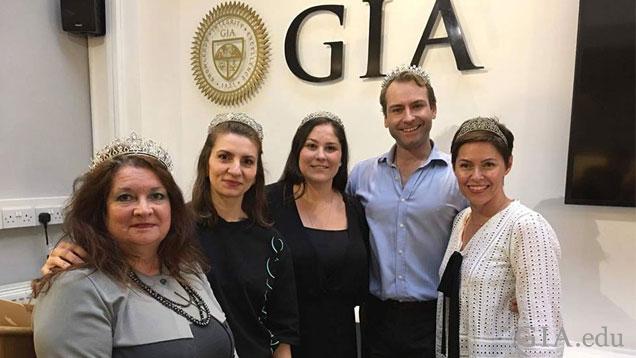 Four woman wearing tiaras stand in a group with Andrew Prince.