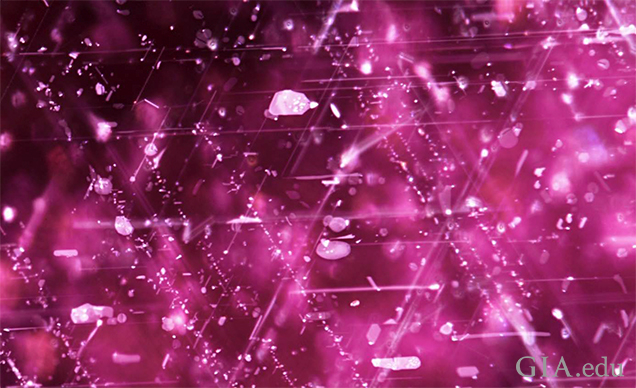 Mozambican ruby with spotted platelets that indicate heat treatment. Fiber-optic illumination. FOV 1.0 mm. Photo: C. Khowpong © GIA. Mozambican ruby with spotted platelets that indicate heat treatment. Fiber-optic illumination. FOV 1.0 mm. Photo: C. Khowpong © GIA.