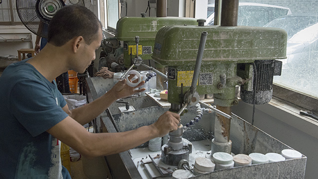 Chinese man manufacturing jadeite bangle Chinese man manufacturing jadeite bangle