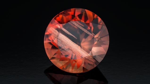 This fine 7.70-ct. red sunstone displays broad bars of aventurescent copper particles. - Robert Weldon This fine 7.70-ct. red sunstone displays broad bars of aventurescent copper particles. - Robert Weldon