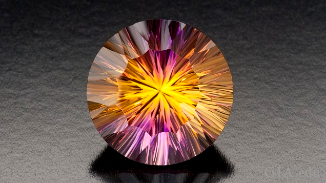 Bursts of yellow and purple radiate throughout this round cut amertrine.